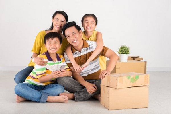 a happy asian family packing their belongings