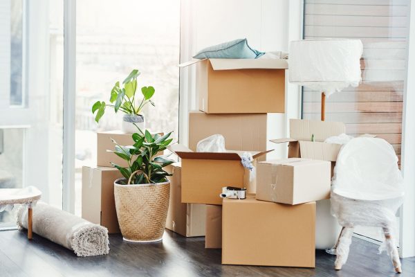 Cardboard boxes stacked in one corner of a room